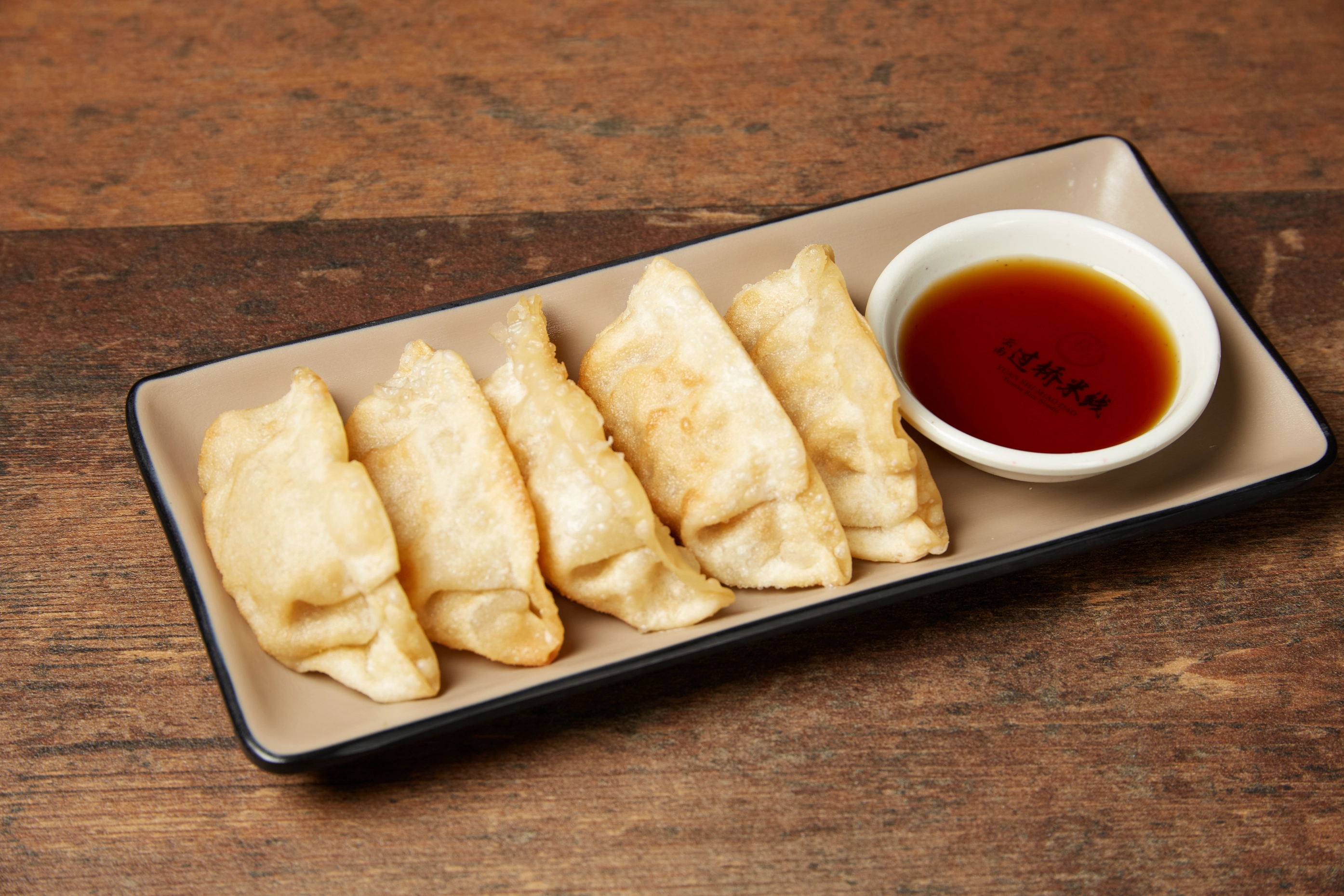Tabletop hot pot feast with dipping sauces and toppings