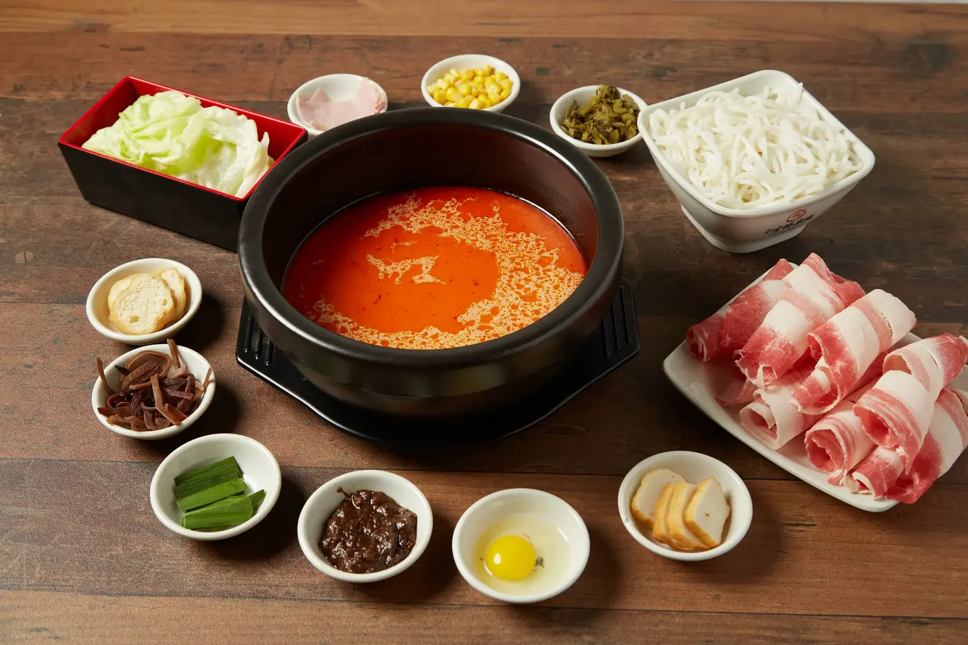 Crossing the Bridge noodle hot pot with fresh toppings ready to stir