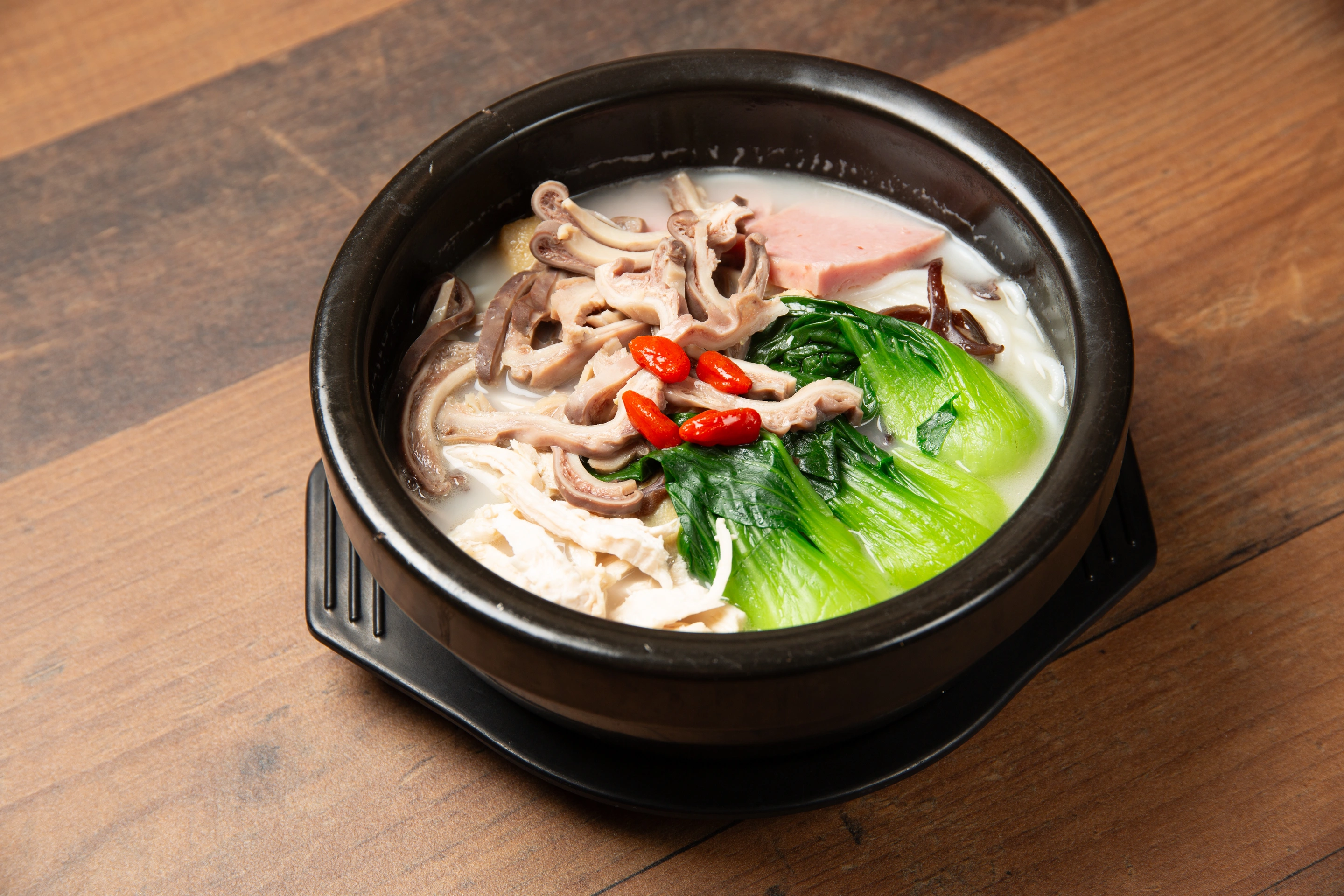 Spicy pork stomach dish finished with peppers and cilantro